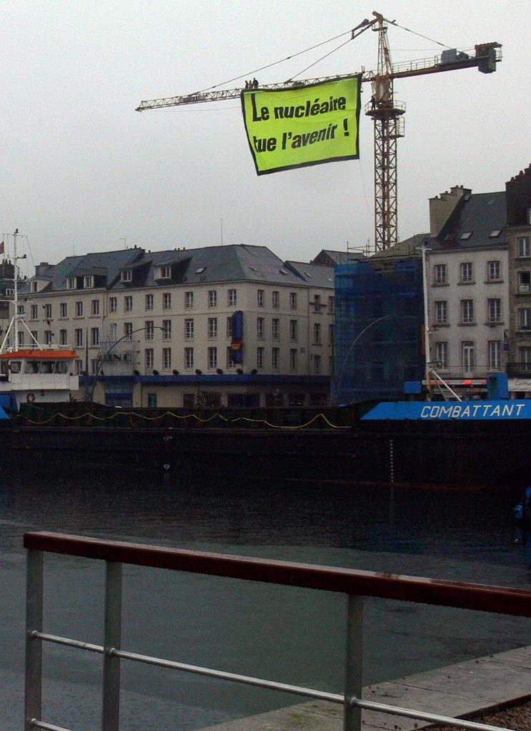 Großes gelbes Banner an einem Kran "Le nucléaire tue l'avenir"